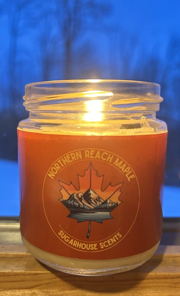 sugarhouse scents maple candle burning at night
