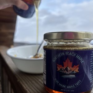 Warmed pure Maine maple taffy being poured over vanilla ice cream.