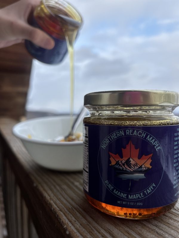Warmed pure Maine maple taffy being poured over vanilla ice cream.