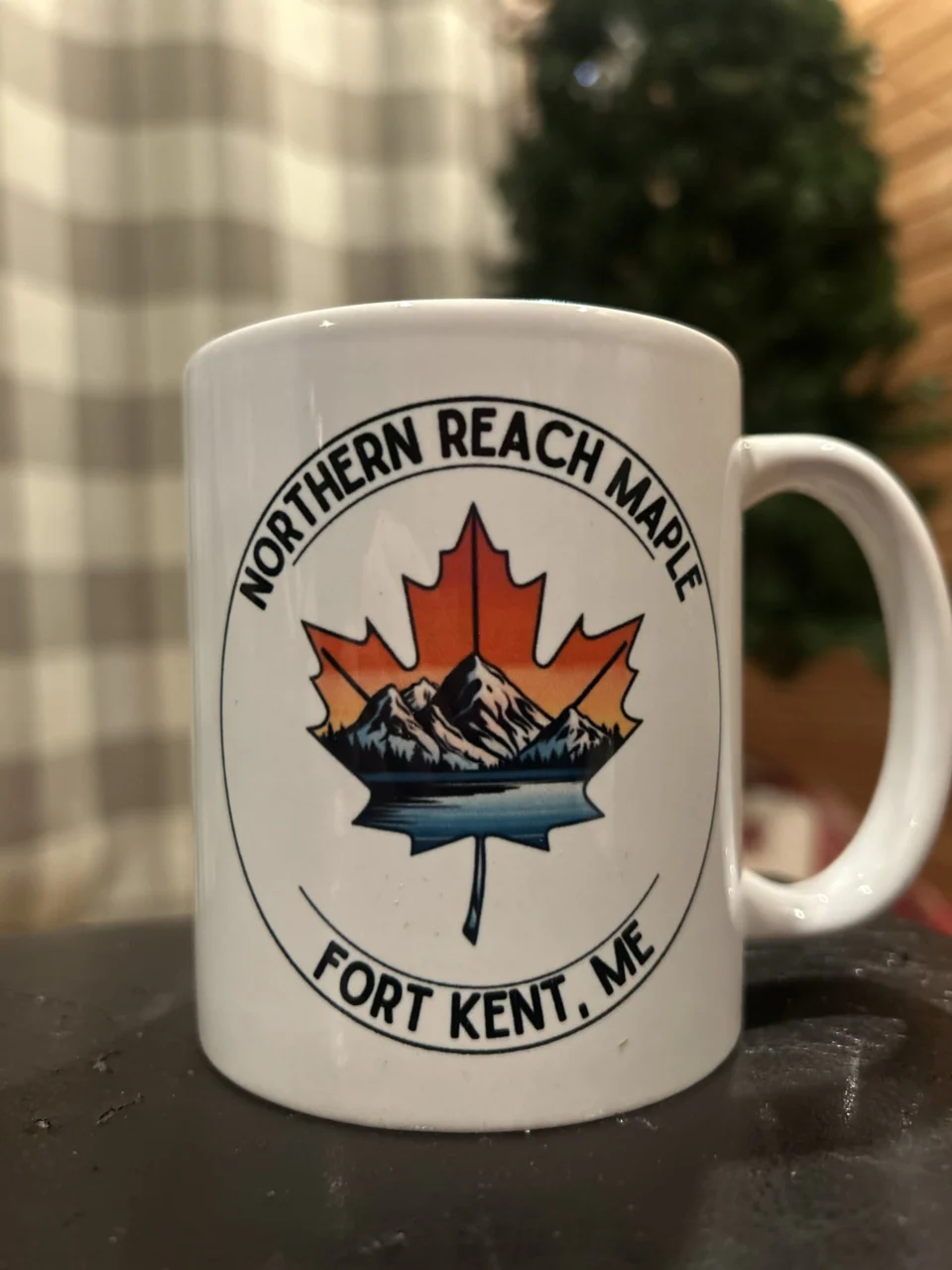 A picture of a coffee mug with Northern Reach Maple's logo printed on it.