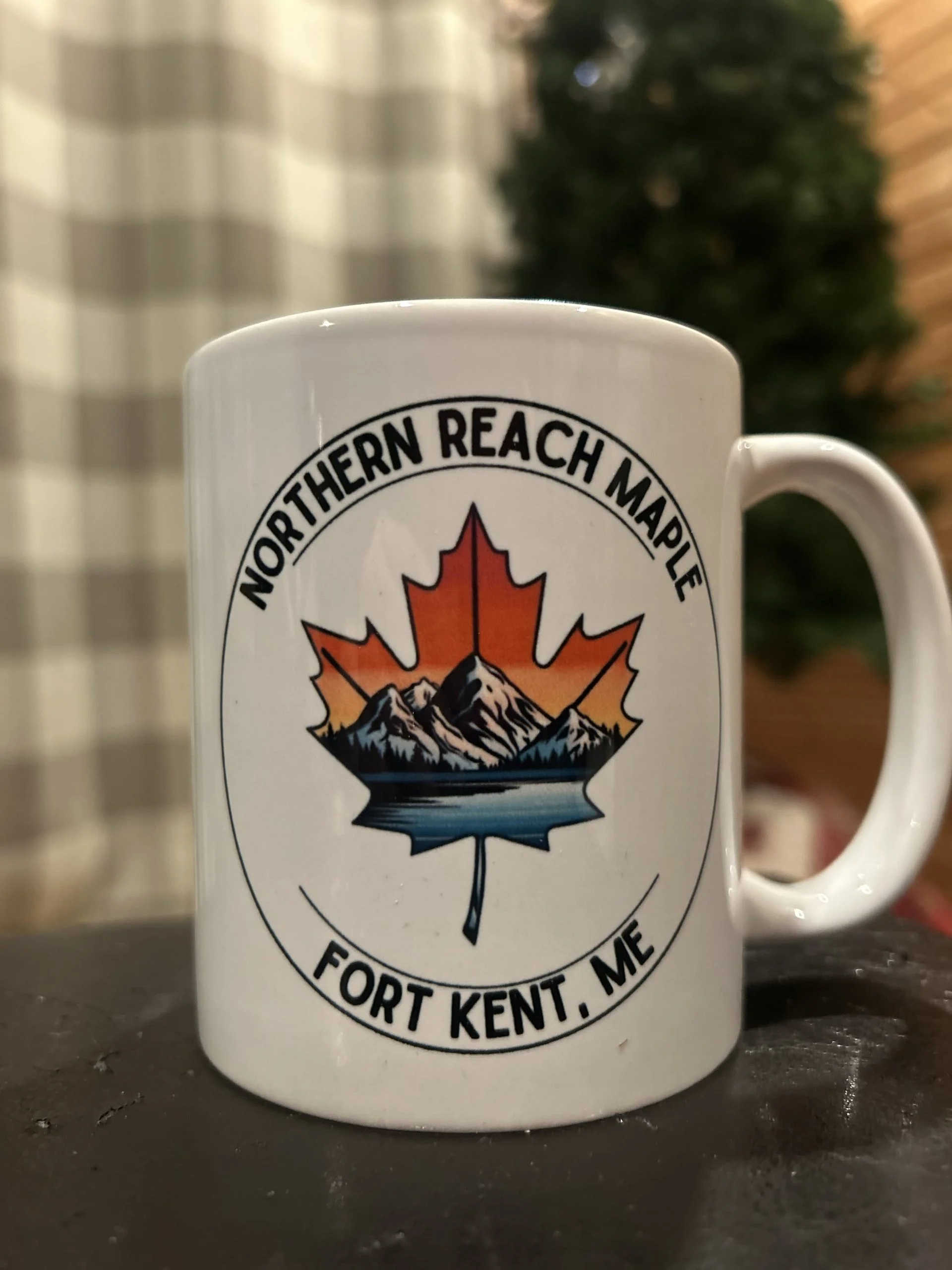 A picture of a coffee mug with Northern Reach Maple's logo printed on it.