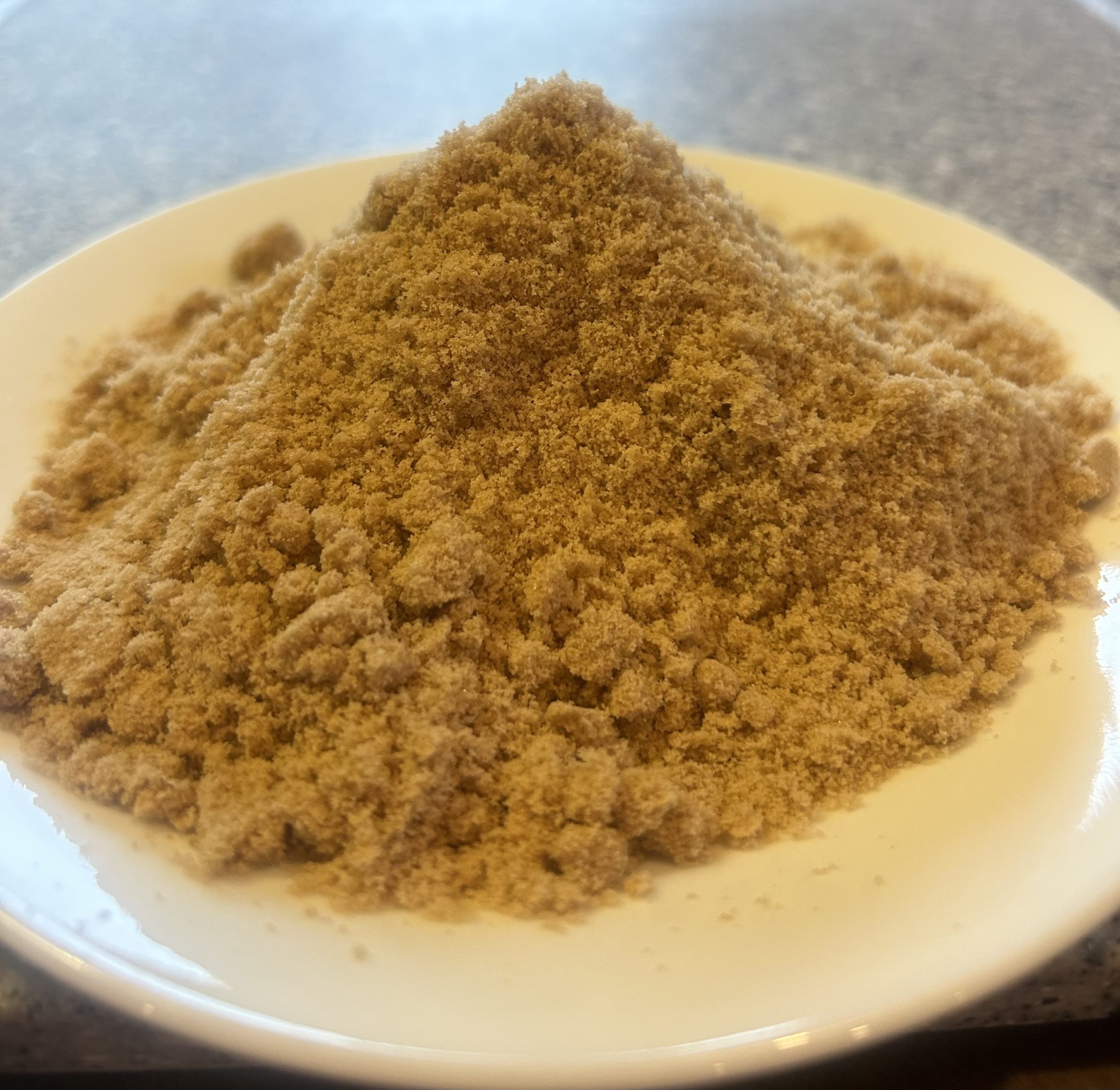 A plate holding Northern Reach Maple's Pure Maine Maple Sugar