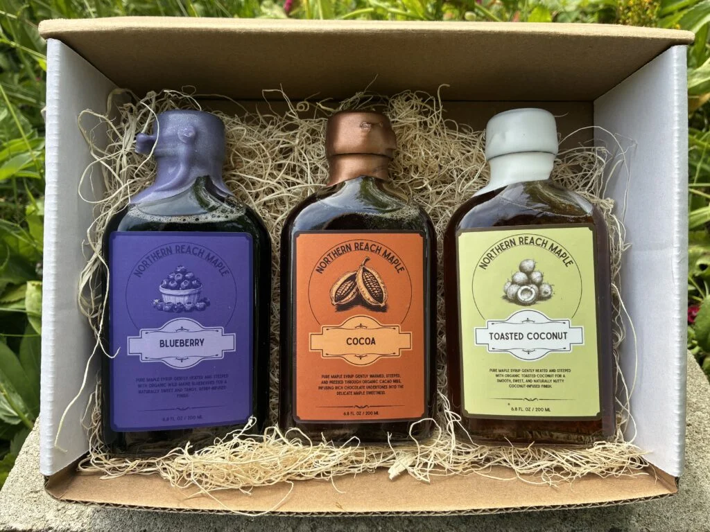 Berry, Cocoa, and Copra maple flavor trio pictured in a mailer box.